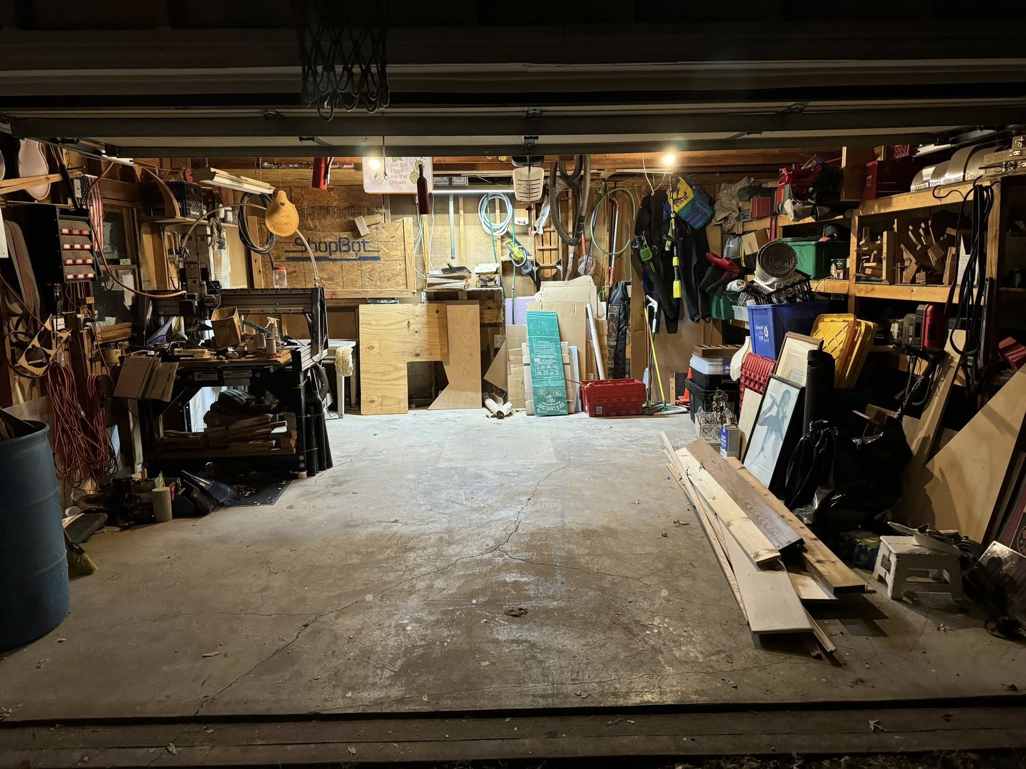 Cluttered garage before Little Fellas Moving cleanout service in Kansas City